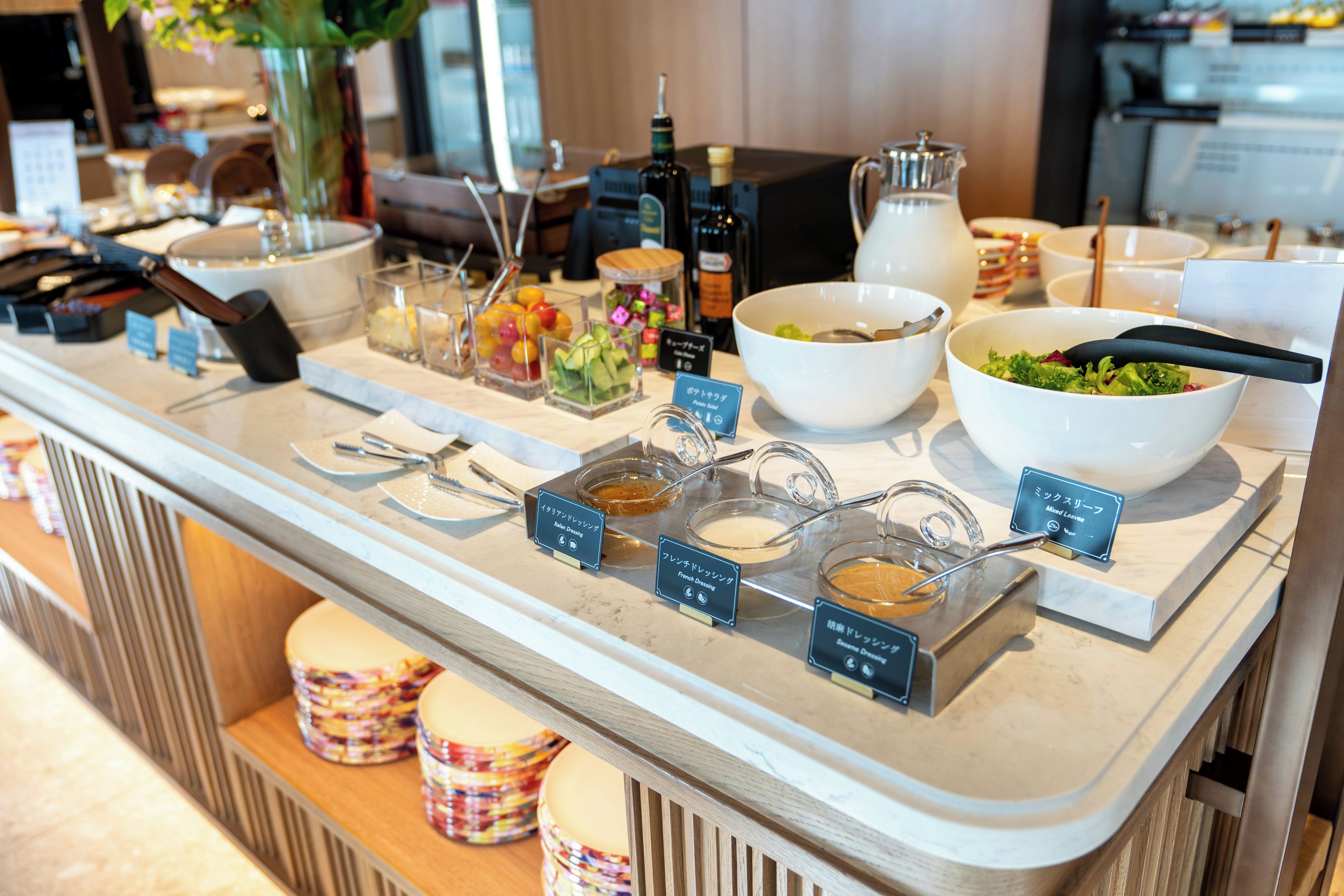 A buffet with various food options and condiments.