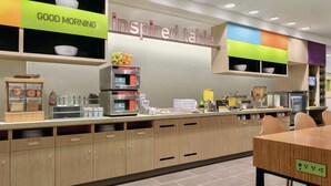 A modern kitchen with a breakfast bar, labeled 'inspired table', and a 'good morning' sign. - Home2 Suites by Hilton Williamsville Buffalo Airport (Buffalo)