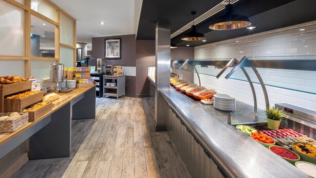 A buffet area with various food items and a coffee station. - Holiday Inn Reading South M4 Jct11 by IHG (Reading)