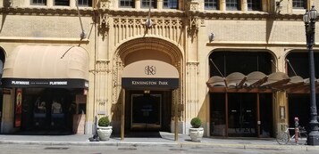 A historic building with ornate architectural details, including a prominent archway with the inscription "Kensington Park."