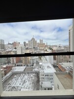 A cityscape with various buildings, including a hotel with a flag on top.
