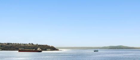 A large body of water with a ferry and a smaller boat.