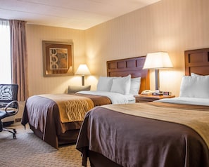 A hotel room with two beds, a desk, a chair, a lamp, a clock, and a framed picture on the wall. - Comfort Inn Wethersfield - Hartford (Wethersfield)