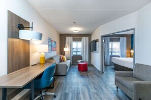 Relax in a stylish room with a comfortable bed, desk, and sofa.