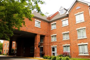 Stunning brick building with a symmetrical facade, featuring evenly spaced windows and a charming entrance.