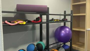 Stay active in our room's compact fitness area, equipped with a variety of exercise equipment.