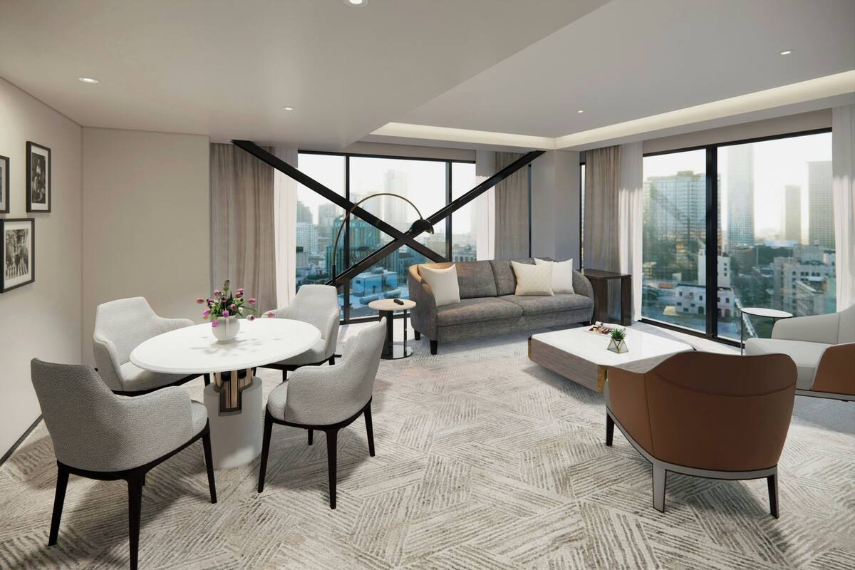 A modern living room with a sofa, chairs, a coffee table, and a dining table.