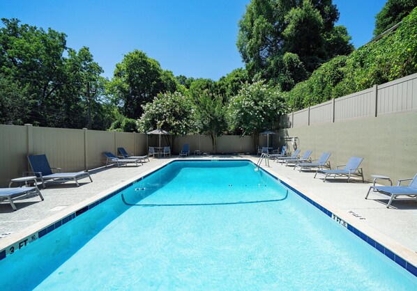 Piscine extérieure en saison, chaises longues