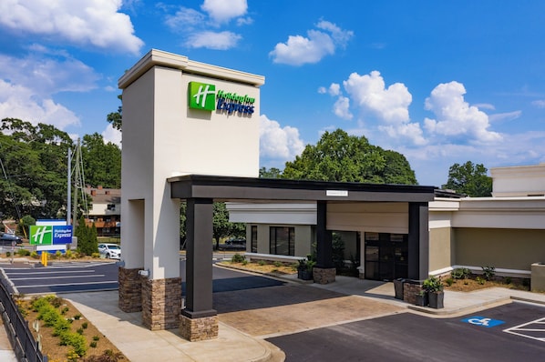 A Holiday Inn Express building with a clear sky and a parking lot.