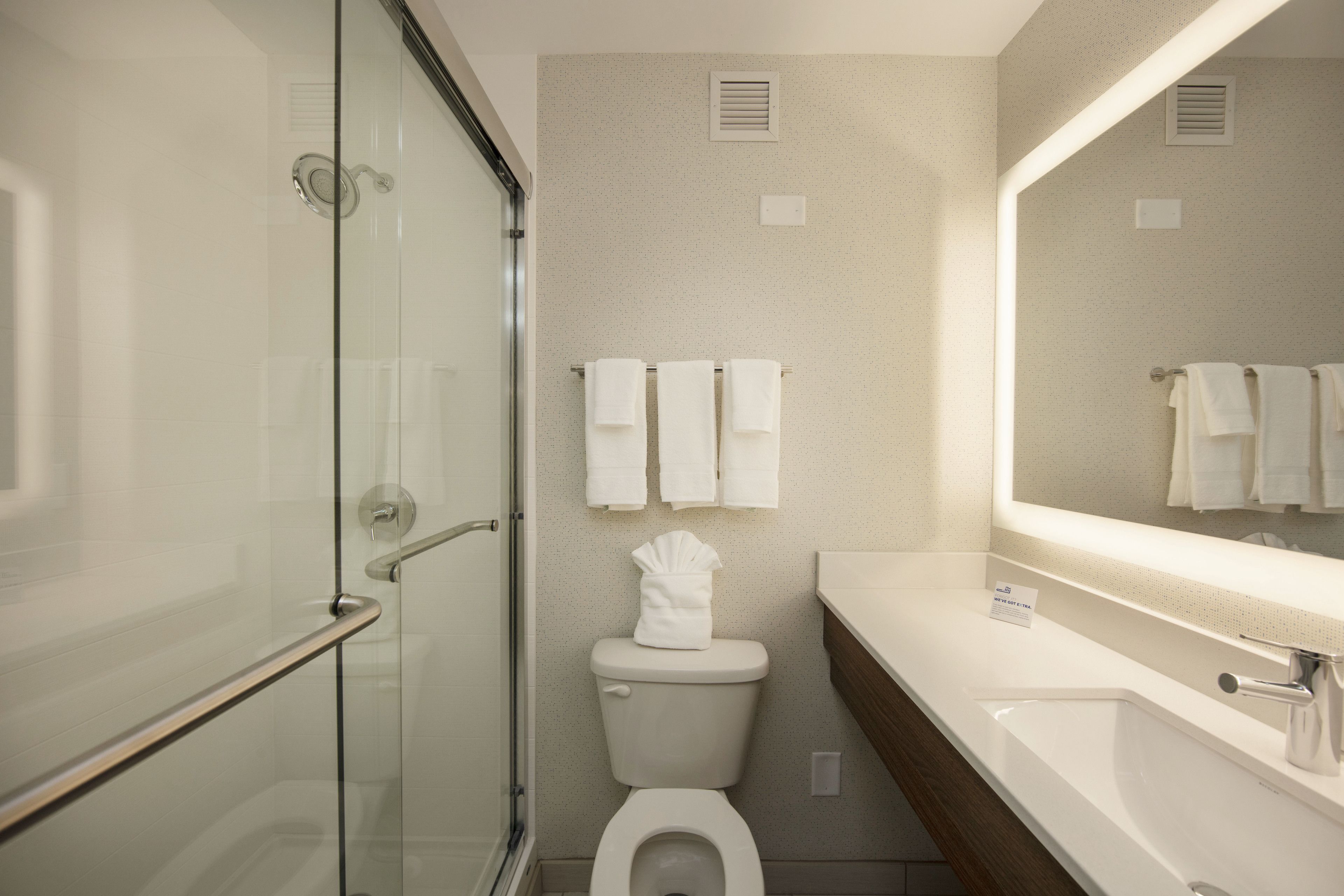 combined shower/bathtub, designer toiletries, hair dryer, towels