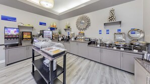 A modern breakfast area with self-service stations, including coffee machines and a variety of food options. - Best Western Canoga Park Motor Inn (Winnetka)