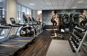 A gym with treadmills, elliptical machines, and weightlifting equipment. - Embassy Suites by Hilton Bethesda Washington DC (Bethesda)