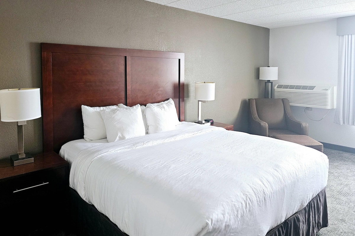 Premium bedding, desk, laptop workspace, blackout curtains