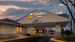 A Comfort Inn hotel with a prominent sign, a covered entrance, and a paved driveway. - Comfort Inn Plymouth - Minneapolis (Plymouth)
