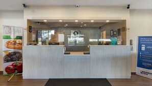 A reception desk with a sign that reads "Quality Breakfast." - Quality Inn Albany Colonie (Albany)