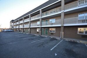 A multi-story parking garage with a row of parked cars. - HomeTowne Studios by Red Roof Denver - Lakewood West (Lakewood)