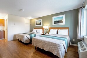 A hotel room with two beds, a bathroom, and a kitchenette. - HomeTowne Studios by Red Roof Denver - Lakewood West (Lakewood)