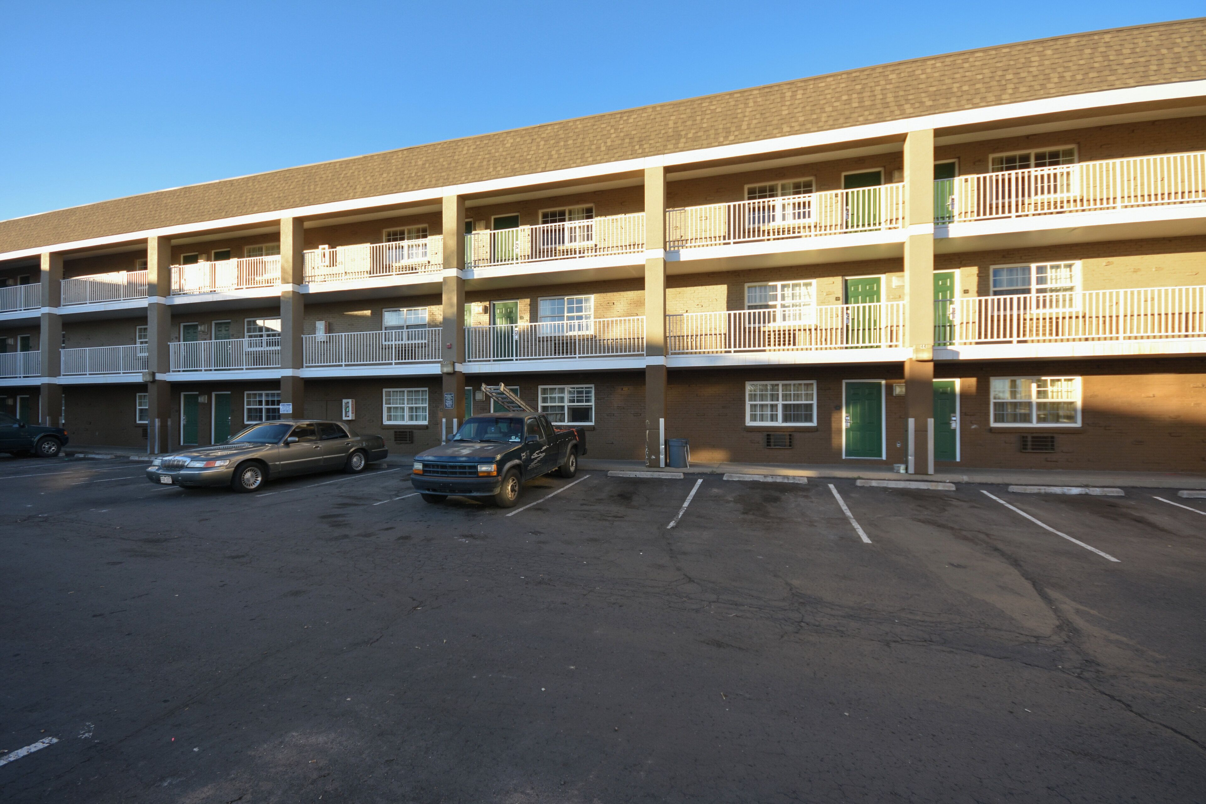 A multi-story parking garage with several cars parked.