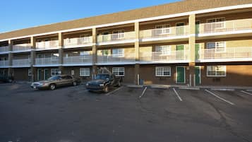 A multi-story parking garage with several cars parked.
