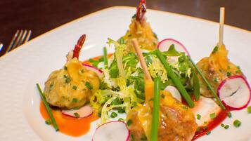 A plate of food with various garnishes and a sauce.