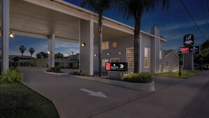 A hotel with a gas station, a sign for Red Roof, and a Bonanza sign. - HomeTowne Studios by Red Roof Yuba City Bonanza – Marysville (Yuba City)