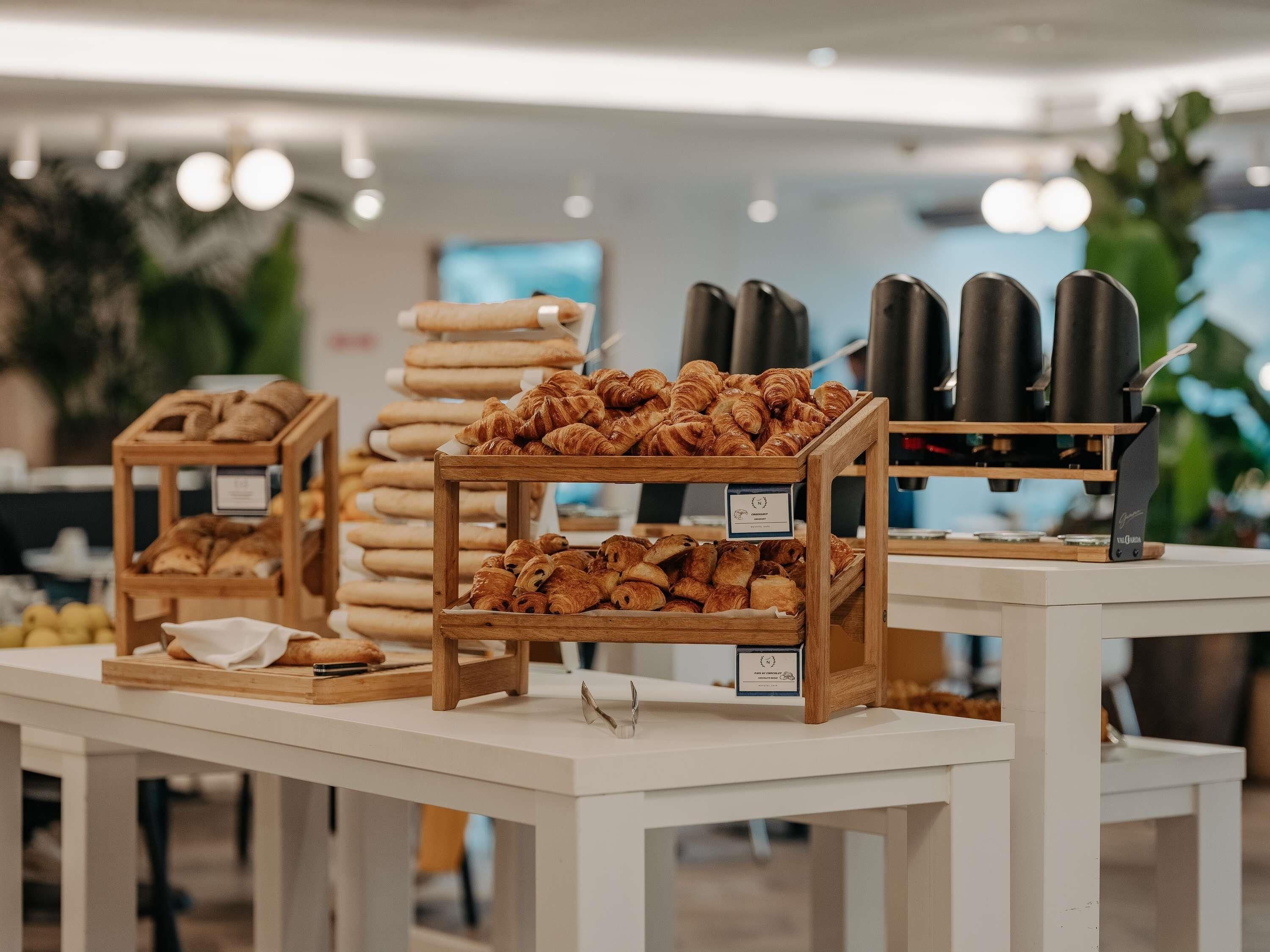 A bakery display with various baked goods and a coffee machine.