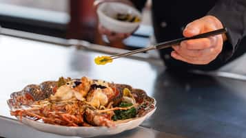 A person using chopsticks to pick up food from a bowl.