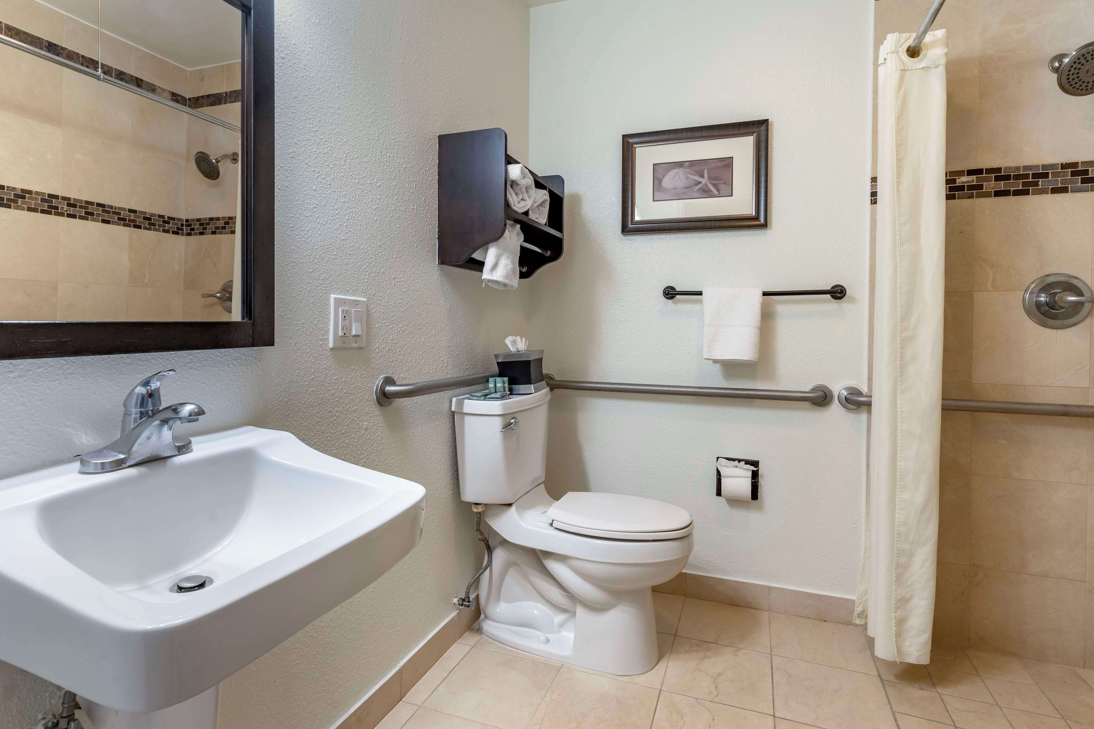 A bathroom with a sink, toilet, and shower.