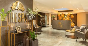 A modern spa lobby with a reception desk, seating area, and decorative plants. - Best Western Victor's Residenz-Hotel Rodenhof (Saarbrücken)