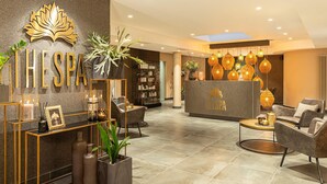 A modern spa lobby with a reception desk, seating area, and decorative plants. - Best Western Victor's Residenz-Hotel Rodenhof (Saarbrücken)