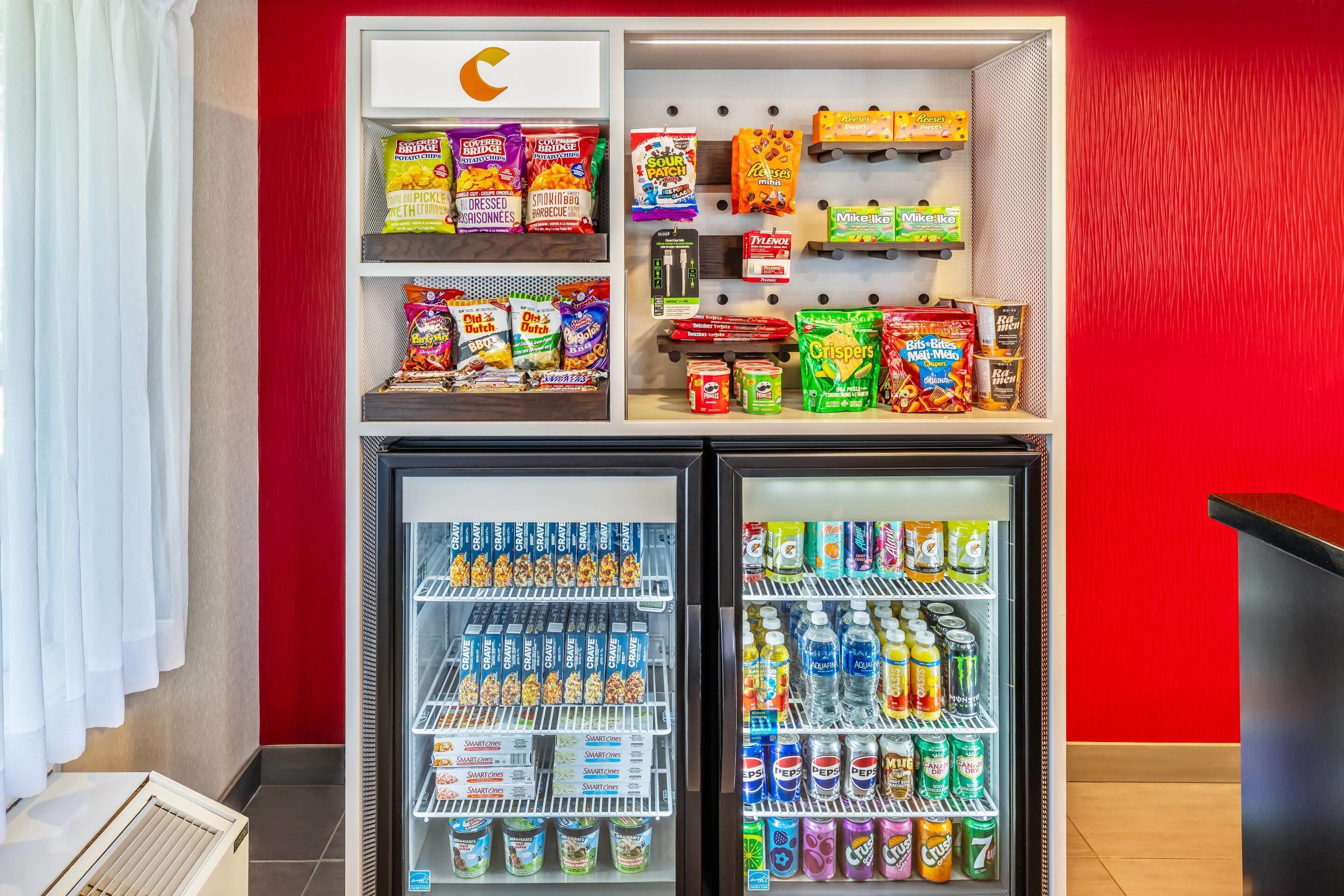 A vending machine with snacks and drinks, including chips, cookies, and bottled beverages.