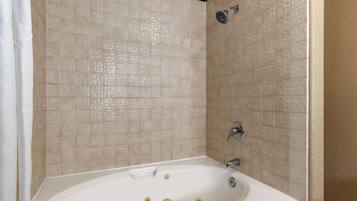 A bathroom with a bathtub, a shower, and a sink.