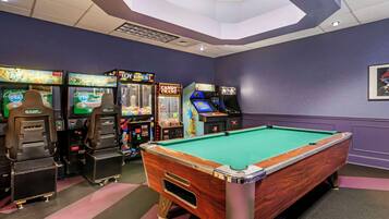 Enjoy games and entertainment in this vibrant room featuring a pool table and arcade games.