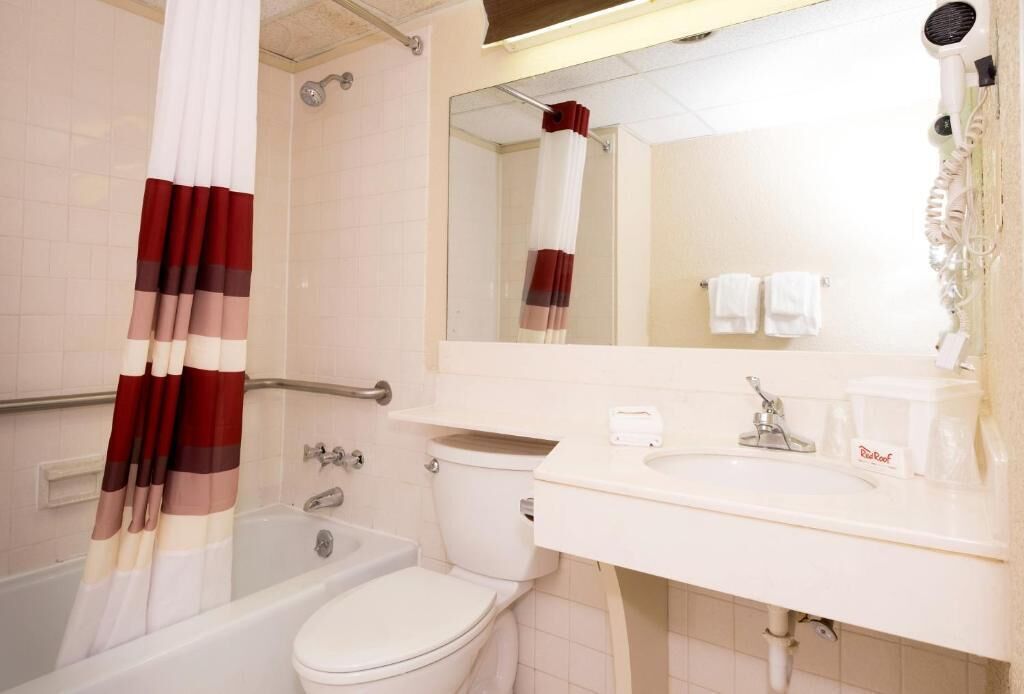 A bathroom with a bathtub, toilet, and sink.