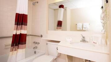 A bathroom with a bathtub, toilet, and sink.