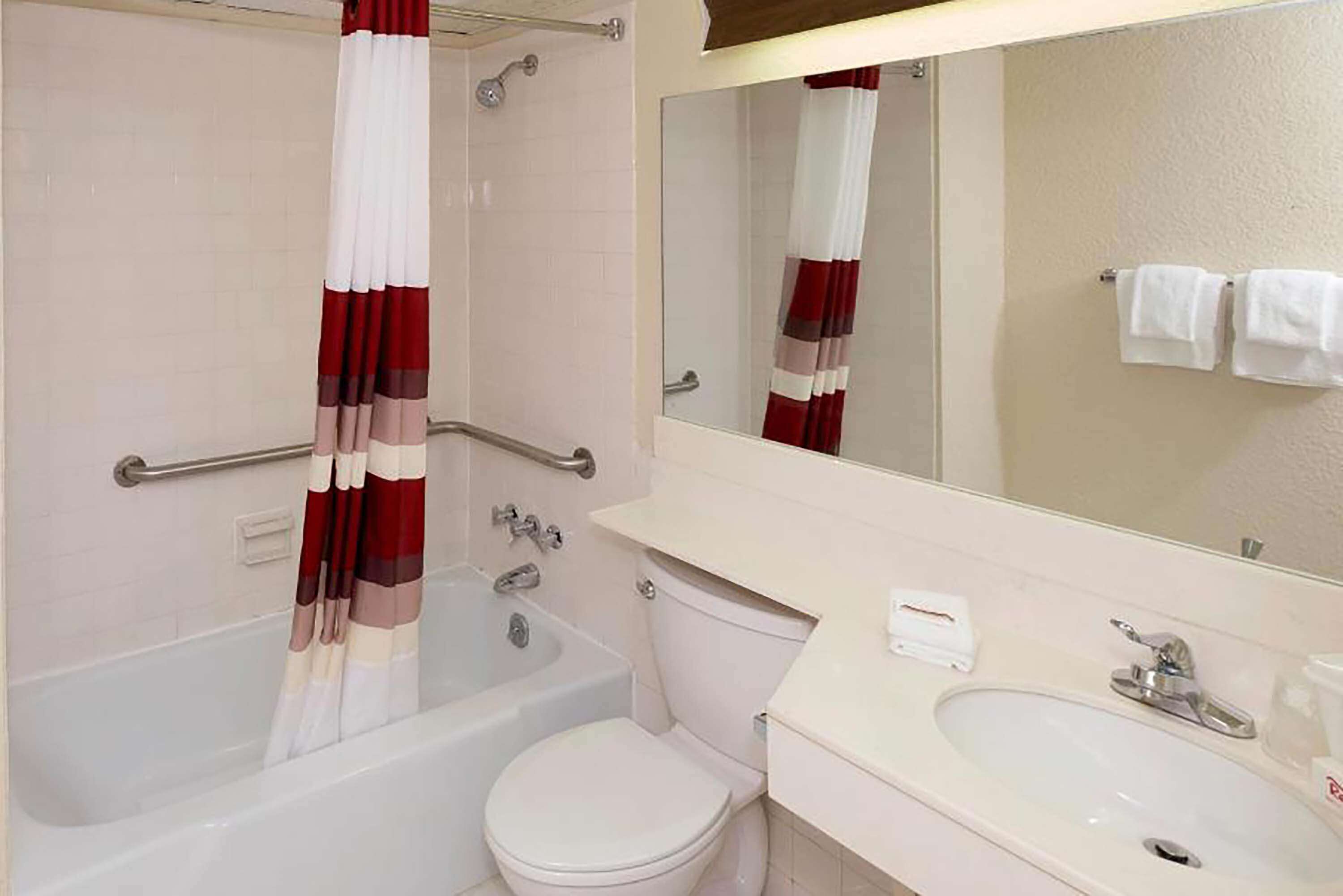 A bathroom with a bathtub, toilet, and sink.