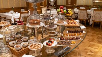 Een buffet met diverse desserts en fruit.