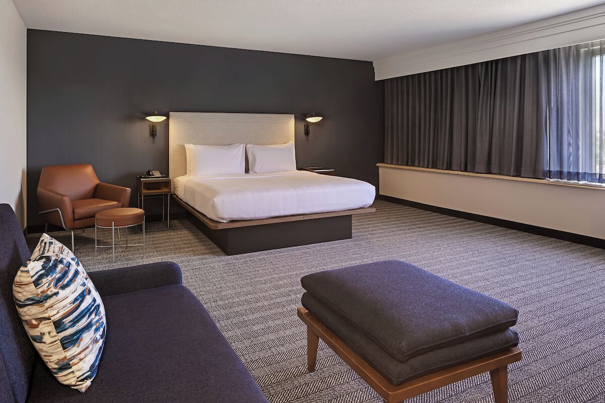 junior suite, 1 king bed with sofa bed, non smoking | in-room safe, desk, laptop workspace, iron/ironing board