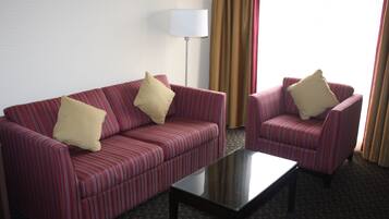 Suite, 1 King Bed, Non Smoking, Fireplace | Living area | 37-inch LED TV with cable channels, TV