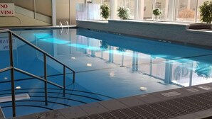 An indoor swimming pool with a 'NO DIVING' sign, clear water, and a metal safety railing. - Radisson Hotel Sudbury (Sudbury)