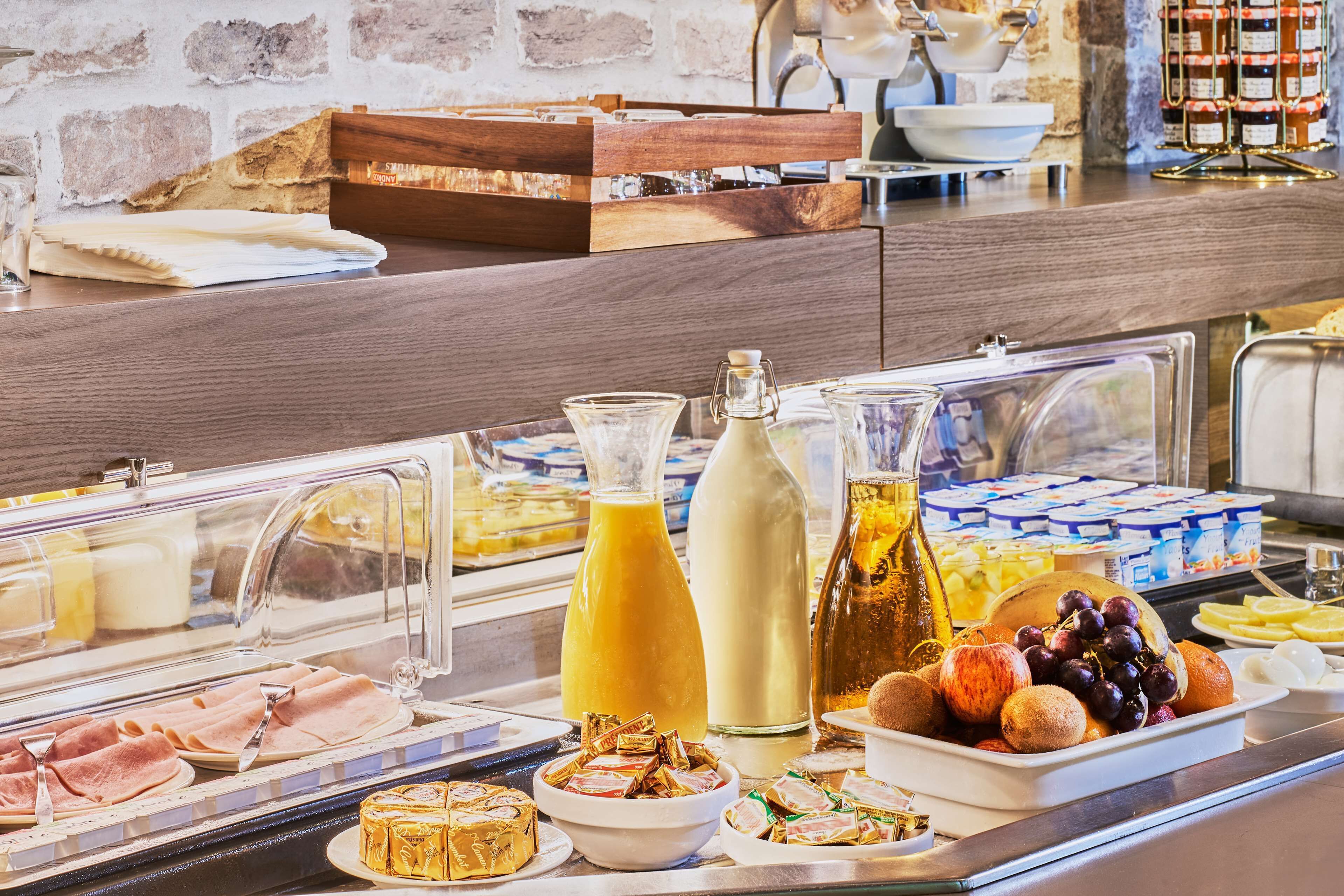 A buffet with various food items and beverages.