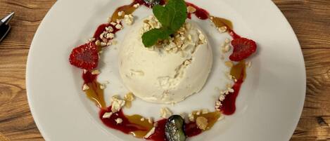 A dessert on a white plate with a wooden table background.