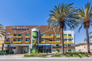 A hotel with a modern facade, a prominent sign, and a landscaped entrance. - Hotel Indigo Anaheim by IHG (Anaheim)