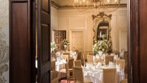A formal dining room with a chandelier, wooden paneling, and a red carpet. - Hintlesham Hall Hotel (Ipswich)