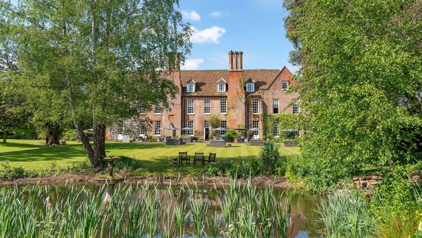 A large brick building with multiple windows and a lawn in front. - Hintlesham Hall Hotel (Ipswich)