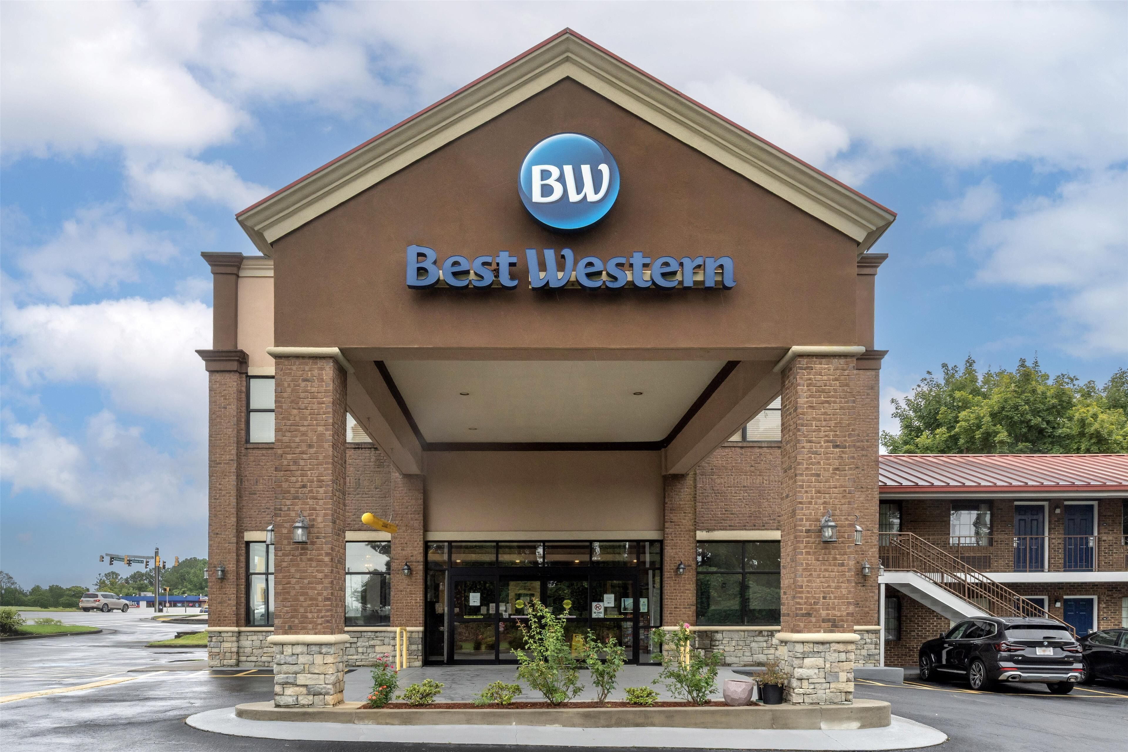 A Best Western hotel with a prominent 'BW' logo, brick facade, and a covered entrance area.
