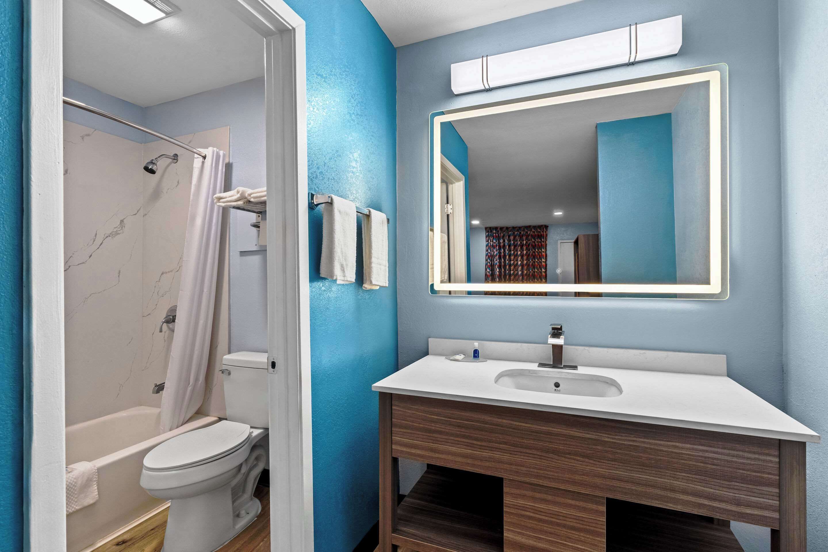 A bathroom with a bathtub, toilet, and sink.