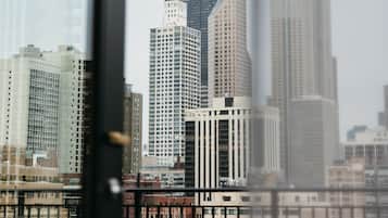 A cityscape with high-rise buildings, including a prominent skyscraper with a unique design.