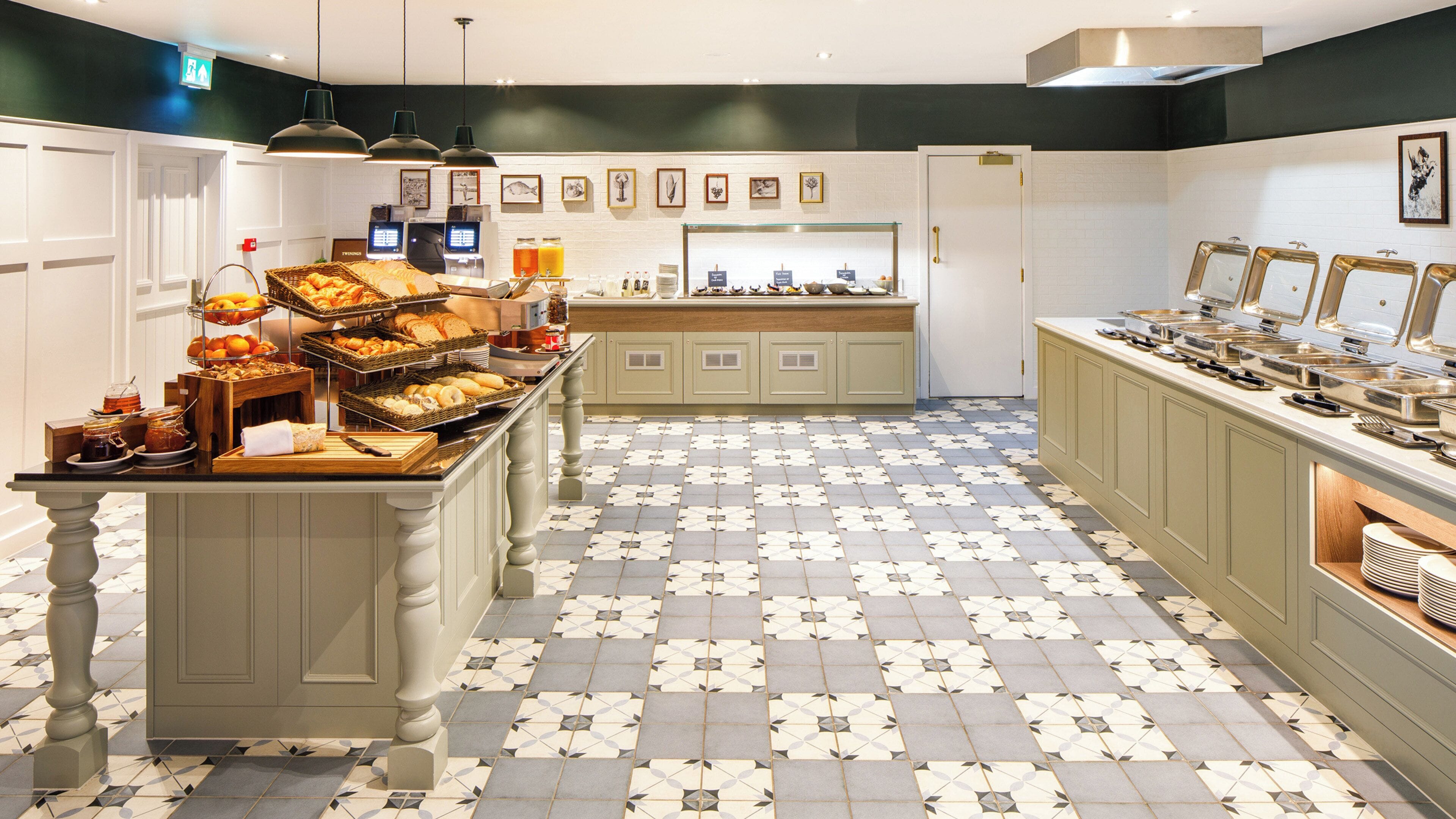 A buffet area with a variety of food items and a tiled floor.