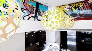 A modern lobby with abstract art on the walls, a reception desk, and a staircase. - Comfort Inn & Suites Baltimore Inner Harbor (Baltimore)